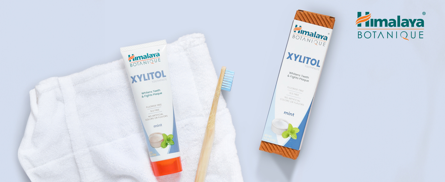 Himalaya Botanique Toothpaste with a toothbrush and on top of a white towel