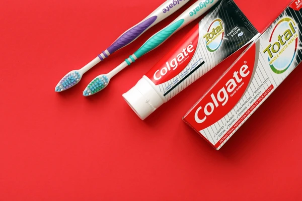 colgate toothpaste with two colgate toothbrushes