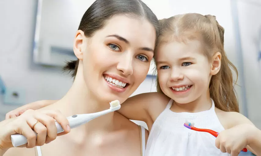 Mother and daughter using nano hydroxyapatite toothpaste n HA as a friendly family choice.