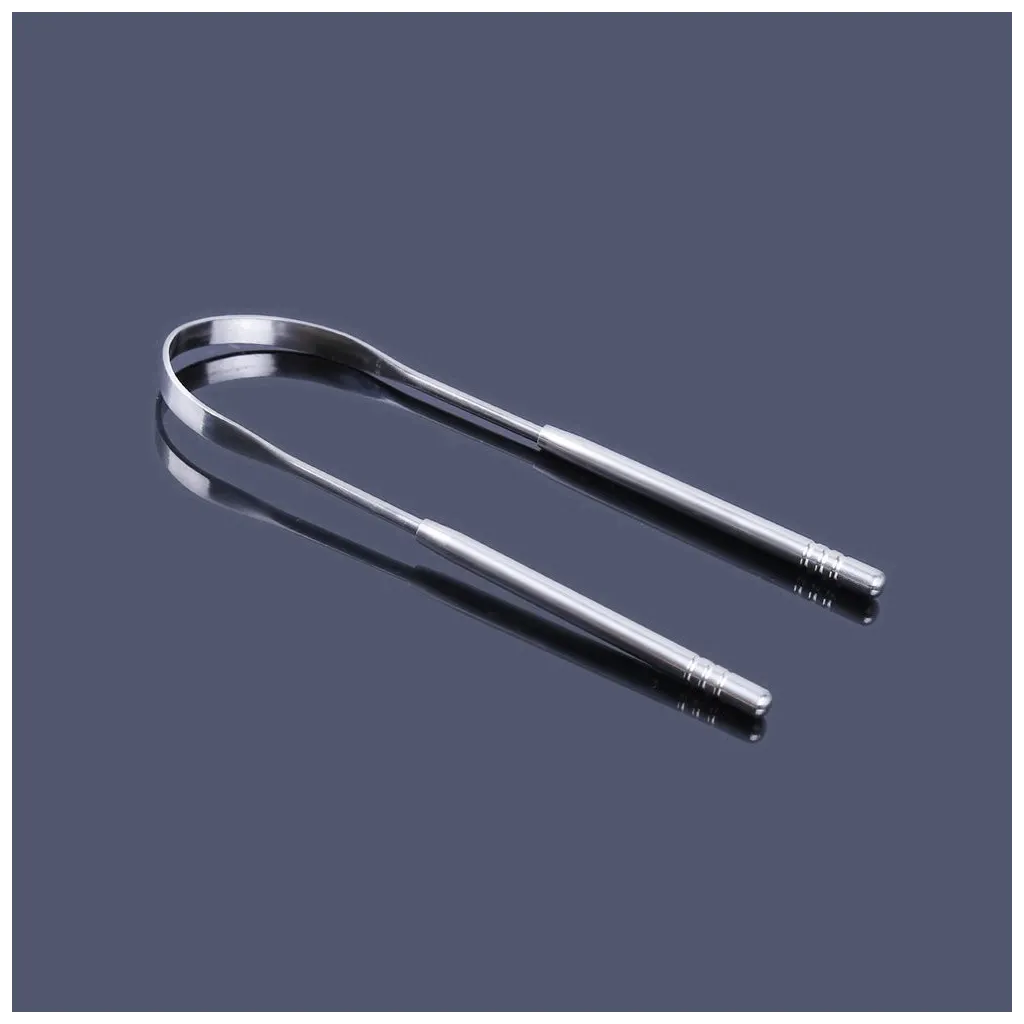 Hand-crafted metal stainless steel tongue scraper on a table