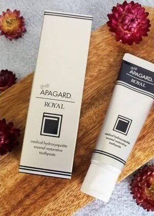 Apagard Royal nano hydroxyapatite toothpaste with premium packaging displayed on a wooden surface for luxury enamel care