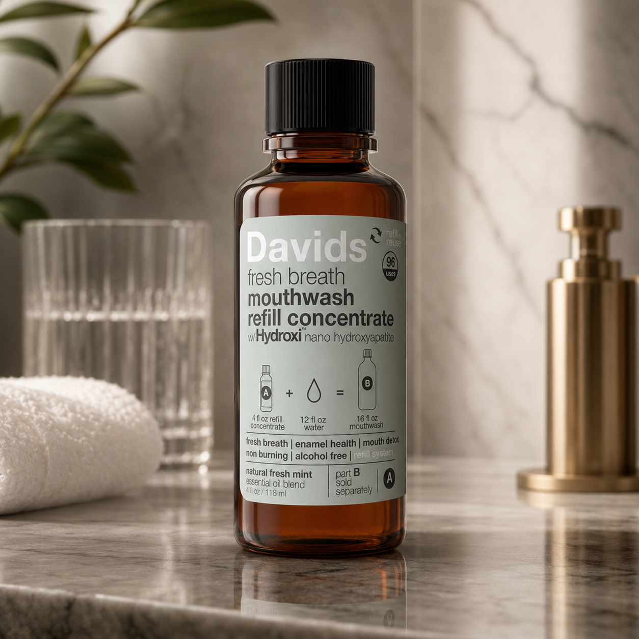 Nano hydroxyapatite mouthwash refill concentrate bottle displayed in a calm luxury bathroom setting with marble countertop, soft towel, glass water cup, and gold accents.