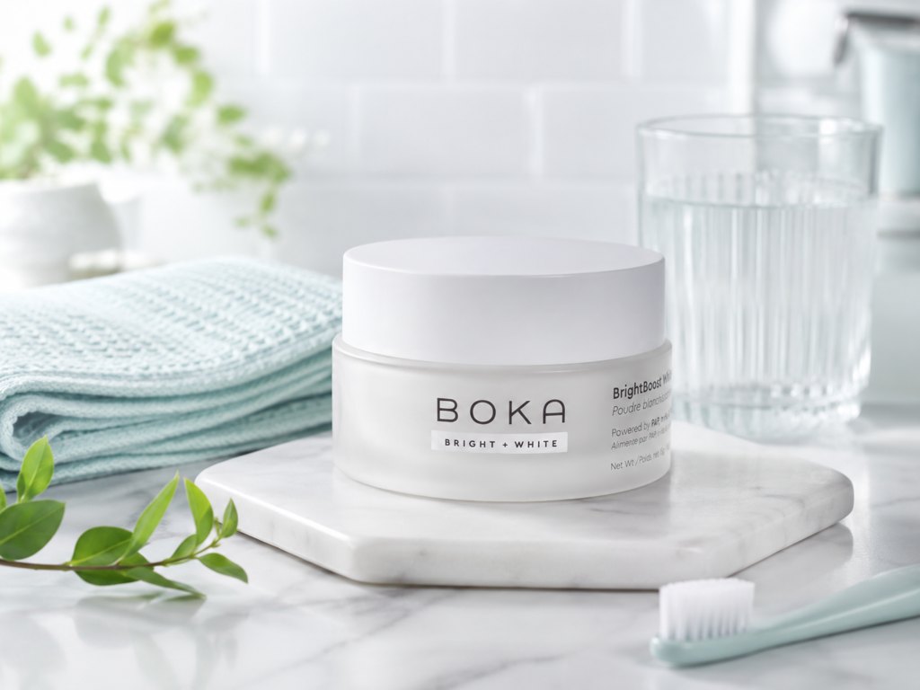 Boka Teeth Whitening Powder displayed in a bright, calm bathroom setting with a mint towel, toothbrush, water glass, and fresh greenery.