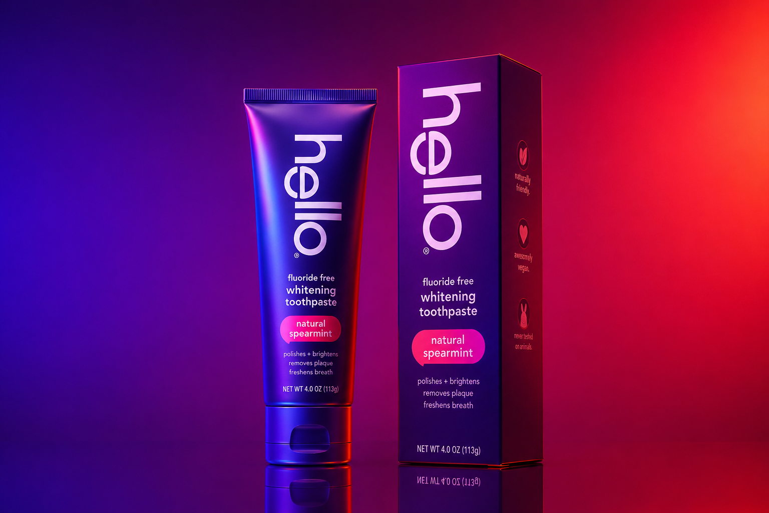 Hello toothpaste tube and packaging displayed in a neon purple and red studio setting with dramatic blue and magenta lighting.